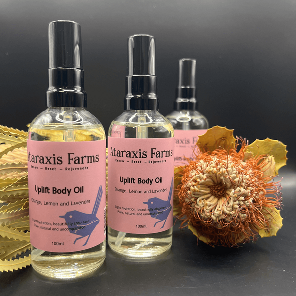 Three bottles of Ataraxis Farms Uplift Body Oil.