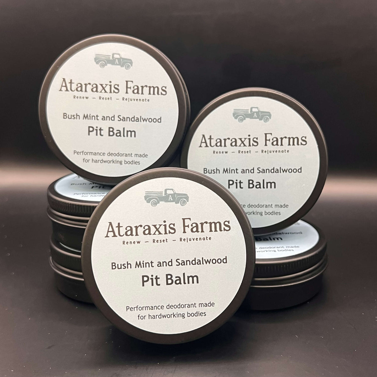 A selection of Ataraxis Farms Pit Balm tins.